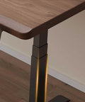Close-up of Straight Up Solid Wood Electric Standing Desk With Drawers, featuring a sleek wood top and sturdy adjustable metal leg.