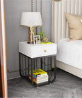 Tough As Nails Metal Frame Nightstand With One Smooth Gliding Drawer And Flat Wipe Clean Top That Parks Right Next To Your Bed Or Sofa For Zero Hassle Storage And Quick Sweep Ups, showcasing modern design with books and lamp.