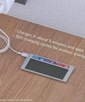 Smart battery charging via USB cable, displays charging message, placed on wood surface, compatible with rapid charging.