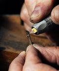 Close-up of Pro Grade 1.49 Inch Precision Tungsten Carbide Micro Drill Bit for Jewelry Making in action on metal.