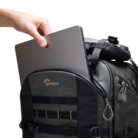 Hand placing laptop in Pro Trekker BP 650 AW II Outdoor Camera Backpack With Weatherproof Cover And Recycled Fabric, Black And Dark Grey.