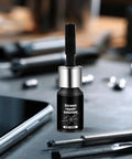 5ml Glass Repair Liquid Quick Fix Universal Fluid bottle on a table with phone and tools, for home use rapid scratch repair