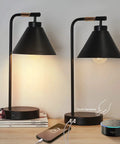Sleek Black Dimmable Nightstand Lamp With USB Ports And AC Outlet, Set of 2 on table, showcasing industrial design with glowing bulbs.
