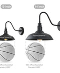 Comparison of 10 inch and 14 inch black outdoor gooseneck barn lights with fixture dome measurements over a basketball.
