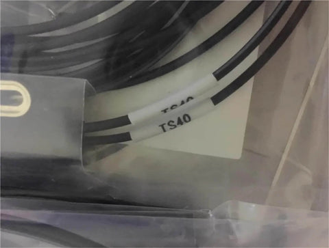 Close-up of LL3-TS40 sensor cable from LL3 fiber optic sensor series for industrial automation and photoelectric sensing.