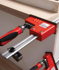 Heavy Duty 31 Inch Fixed Jaw Parallel Clamp Boasts Rock Solid Zero Sag Grip With Non Marking Pads used on wood.