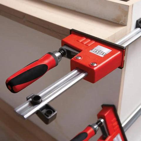 Heavy Duty 31 Inch Fixed Jaw Parallel Clamp Boasts Rock Solid Zero Sag Grip With Non Marking Pads used on wood.