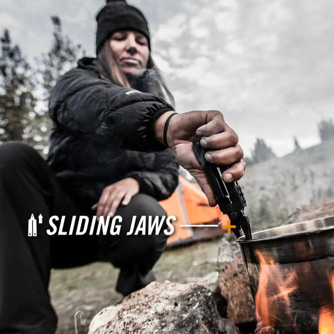 Person using 14-In-1 Multitool With Needlenose Pliers, Serrated Knife, Wire Crimper, Bottle Opener, Can Opener And Screwdriver outdoors
