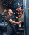 Heavy Hitter Portable Magnetic Base Drill Machine With Brushless Motor 18V Cordless Power Tool in use on steel structure.