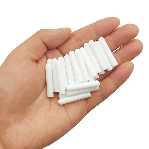 Hand holding 100 Pcs Universal Silicone Dishwasher Rack Tine End Caps Round Tip Caps For Wire Prongs Tine Repair Kit Anti Slip White 1 Inch