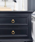 Black dresser with gold ring drawer knobs installed