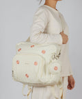 Woman carrying Diaper Bag Backpack For Moms Large Capacity Baby Travel Backpack With Changing Pad Insulated Bottle Pockets Medium Beige Floral