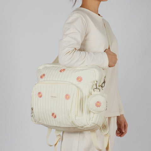 Woman carrying Diaper Bag Backpack For Moms Large Capacity Baby Travel Backpack With Changing Pad Insulated Bottle Pockets Medium Beige Floral