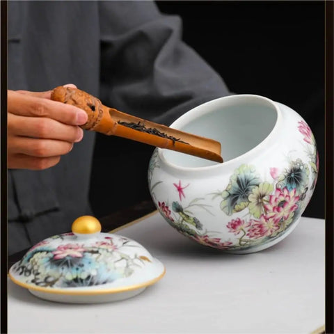 Hand-Painted Floral Ceramic Tea Canister With Legit Airtight Seal For Loose Tea, Coffee Beans, And Pantry Staples being filled with tea.
