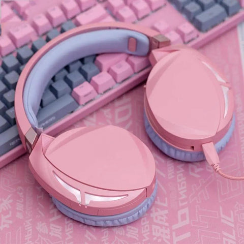 Dope Pink Mechanical Gaming Keyboard And Mouse Combo With Full Spectrum RGB Backlighting Smooth Action Keys And Ultra Portable Mouse Pad, pink wired headset next to keyboard.