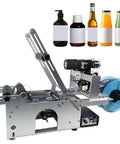 No Sweat Semi Automatic Label Applicator And Manual Bottle Labeler With Built In Date Coder For Round Glass Plastic Containers And Metal Cans, showing machine with labels and various bottles.