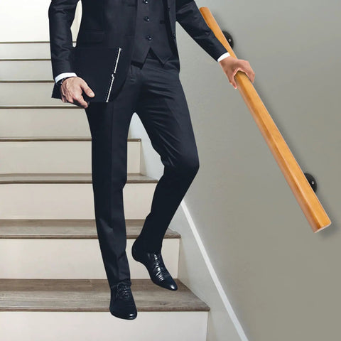 Rock Solid Pine Wood Stair Handrail With Legit Heavy Duty Metal Brackets And Smooth Rounded Corners For Reliable Indoor Wall Mount Support Carrying Groceries Or Packages No Sweat, viewed with a man in a suit on stairs.