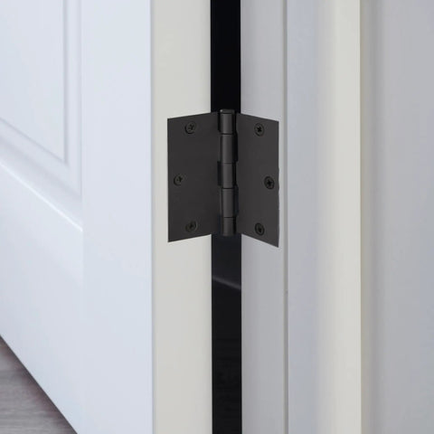 Close-up of Ten-Pack 3.5-Inch Interior Door Hinges With Square Corners Matte Black Heavy Duty Steel Construction mounted on door