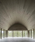 Chill Coastal Beachwood Water Based Wood Stain Zero VOC used on vaulted wood ceiling in spacious room with large windows.