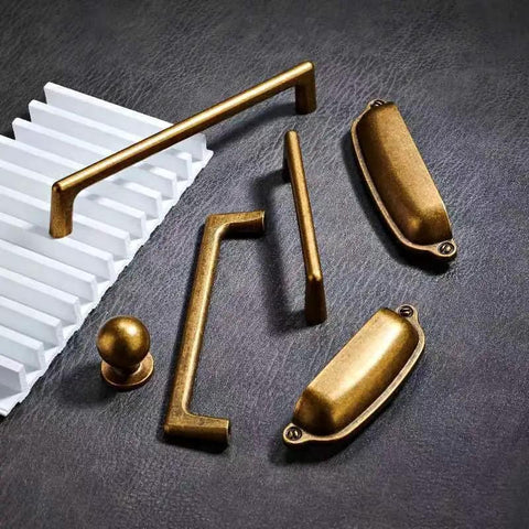 10 Pack 3 Inch Antique Brass Cabinet Pulls Swanky Bin Cup Drawer Handles showcasing five different styles on a dark background.
