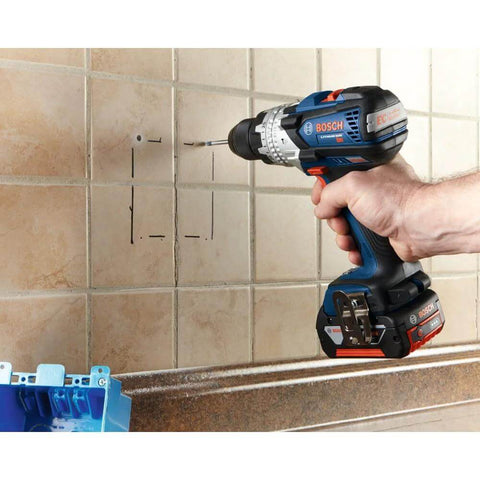 Side view of blue and black Bosch cordless drill drilling into ceramic tile.