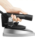 Pro Grade Industrial Electric Steam Iron Bringing Killer 1200W Heat And Zero Grind Titanium Gold Soleplate Heavy Duty Clothing Presser in hand.
