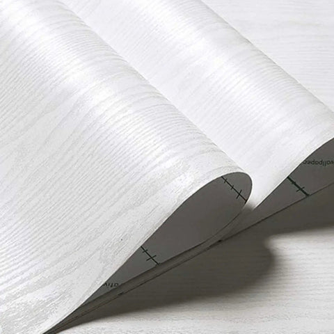 Close-up of white wood grain peel and stick wallpaper 15.7 inch by 196 inch, showing real wood texture and self-adhesive backing.