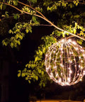 Three Pack 12 Inch LED Globe Lights For Indoor Outdoor Use Waterproof And Durable Warm White Orbs hanging on a tree