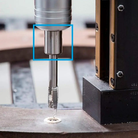 Close-up of Top Notch 3 4 Inch Weldon Tap Adapter With 1 4 Tap Collet in action on steel plate for threading.