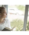 Person looking through a window fitted with a 2 Pack Mosquito Net For Windows Upgrade Fly Window Screen Mesh Insect Netting 1.5m x 2m