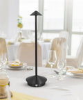 Black aluminum Cordless Table Lamp with 6000mAh Battery on dining table, modern design, ideal for indoor outdoor lighting, touch switch.