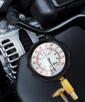Close-up of BETOOLL 0-140 PSI fuel injector pressure tester gauge kit with brass fittings on a car engine.