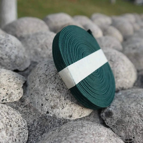 Durable Ito Sageo Wrapping Cord For Katana And Wakizashi 16.4 Foot Synthetic Silk coil on stone surface