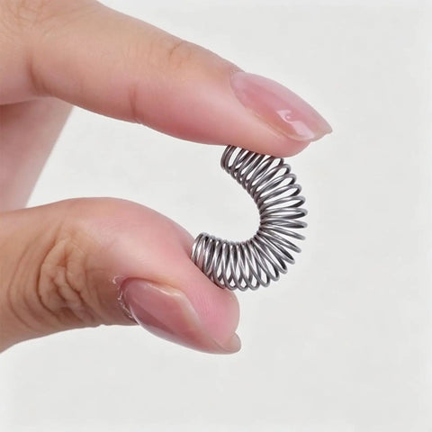 Grab This Killer SENRISE Compression Spring Kit With 300 Durable Stainless Steel Coils And 23 Sizes For All Your Mechanical Fixes, Switches, Reset Parts And Tool Builds Without Breaking The Bank Or Losing Mind. Close-up stainless steel compression spring held between fingers