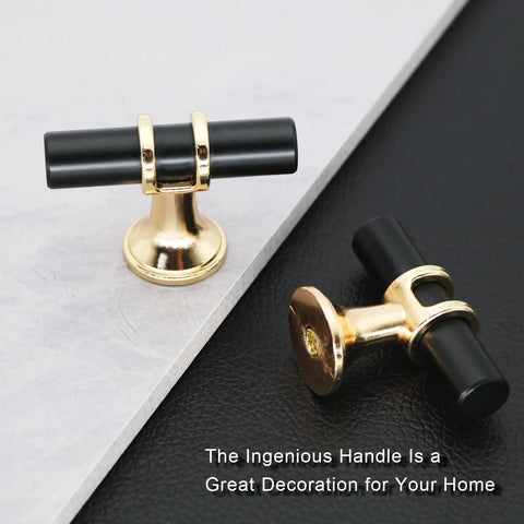 Two T Bar knobs on a black surface, part of the 10 Pack Black And Gold Cabinet Pulls T Bar Knobs For Kitchen And Bathroom Cupboards No Fuss Single Hole Handles For Dresser Drawers With Easy Install Screws Included