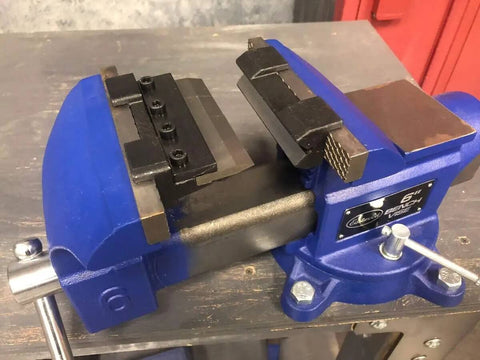 Close-up of a blue 4 Inch Vise Mount Press Brake Bender Attachment for Sheet Metal Cross Slide, mounted on a workbench.
