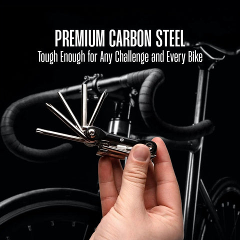 Hand holding 12 In 1 Bike Multitool Kit Lightweight Stainless Steel Bicycle Tool with Hex Key and Screwdriver against bike background