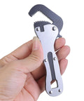 Miniature Rough Wrench Spanner With Ergonomic Grip For Quick Fixes In Furniture Assembly Automotive Repairs And Electronics A Compact Handy Tool For Tight Spaces And Precise Adjustments For DIYers And Pros shown in a person's hand, showcasing its compact size and ergonomic grip.