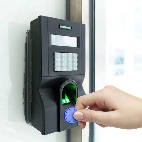 Hand using Rewritable 13.56MHz UID Key Fobs Pack Of 100 For Easy Access Control at a door reader for entry, NFC RFID compatible.