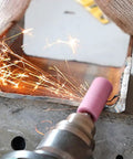 Rotary Tool Grinding Stone Set With One Eighth Inch Shank Aluminum Oxide Bits in use on metal surface, sparks visible