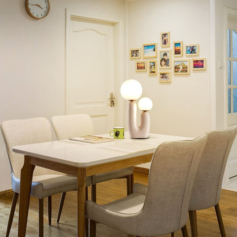 Double-Headed Nordic Modern Table Lamp With Plant Art, Bedside Nightstand Light on dining table with chairs in cozy room