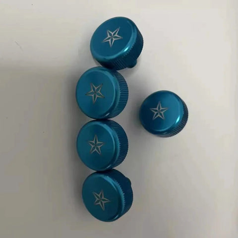 Five blue star-engraved round knobs on a white background
