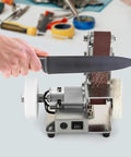 Cool Mini Bench Grinder And Sander Machine With Stainless Steel Build sharpening a knife, showing adjustable speed and reverse mode.