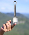 Ultralight Titanium Spork For Backpacking And Camping Doubles As Spoon And Fork With Carabiner Loop outdoors on fingertip view