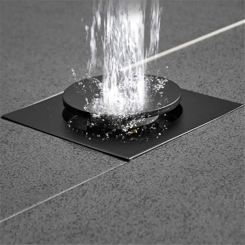 Drop Down Square Pop Up Floor Drain With Matte Black Chrome Cap And Odor Locking Grille For Bathrooms showing water flow.
