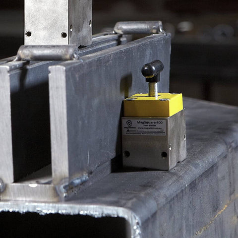 Magnetic Welding Square Base Clamp Holder With On Off Capabilities And Beefy 400 Pound Holding Force For Welding Kits And Fixturing in use on a metal surface.