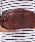 Man holding Leather Toiletry Bag For Men On The Go Grooming Travel Kit With Waterproof Lining Buffalo Leather Build