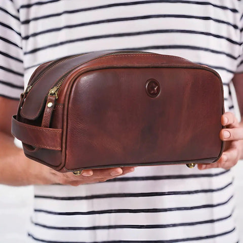 Man holding Leather Toiletry Bag For Men On The Go Grooming Travel Kit With Waterproof Lining Buffalo Leather Build
