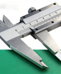 Close-up of Vernier Caliper 0-150mm Manual Micrometer with smooth sliding mechanism on green surface