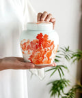 Top Tier Ceramic Tea Canisters Set For Loose Tea Leaves And Coffee Beans, Slick Airtight Storage Jars in hand with floral design.